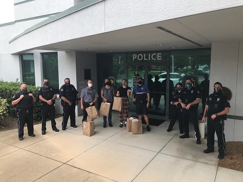 Lewis Heaster, Wild Rabbit owner Laura Hannan and server Alexis with officers of the Ormond Beach Police Department. Courtesy photo