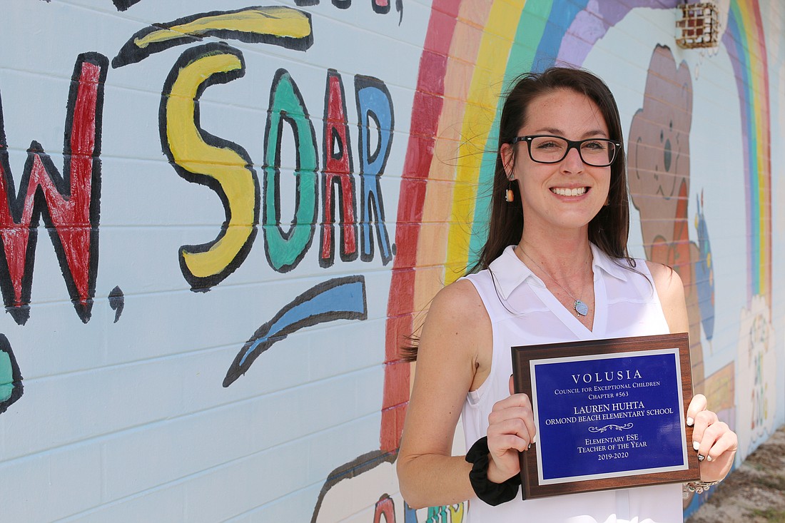 Lauren Huhta stands in front of her favorite mural at Ormond Beach Elementary. Photo by Jarleene Almenas
