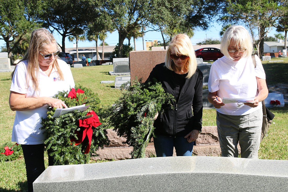 DAR members Julie Johnson, Donna Dienno and Leslie Madigan  lay wreaths on veterans' graves during last year's Wreaths Across America service at Hillside Cemetery. File photo