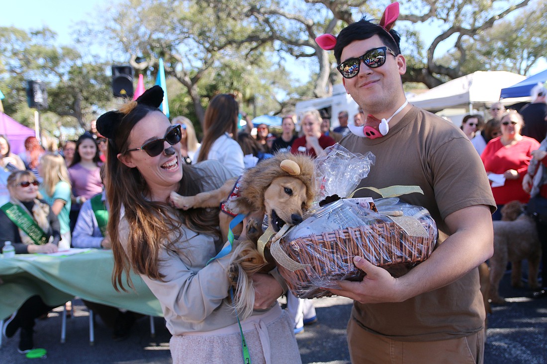 Katherine DeRosa and Izis Cordon, of Ormond Beach, with their hungry pup Winslow, who won the small dog costume contest at OMAM's Dogapalooza 2020. File photo