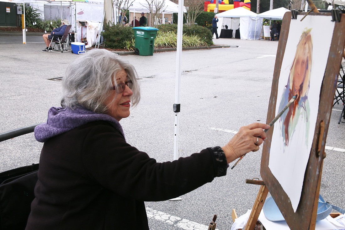 Artist Barbara Perrotti paints a portrait of Nancy Lohman live during the Granada Grand Festival of the Arts in 2020. File photo by Jarleene Almenas