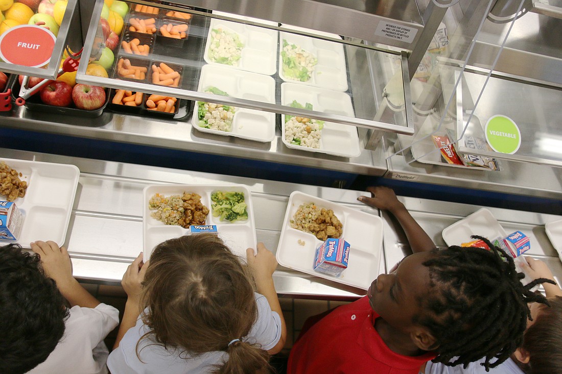 Children line up for lunch at Osceola Elementary in 2019. File photo