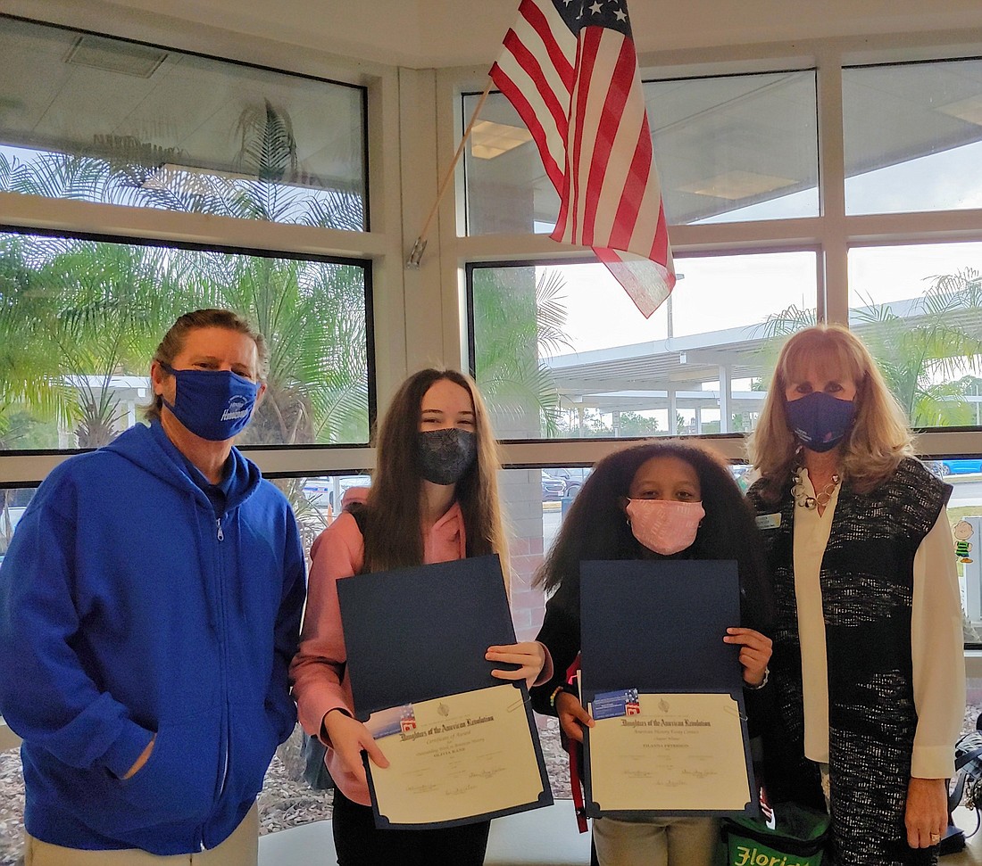 Hinson Middle School teacher Joe Vetter, second Place winner Olivia Kane, firs place winner Tilanna Peterson and DAR American History Chair Karen Knowles. Courtesy photo