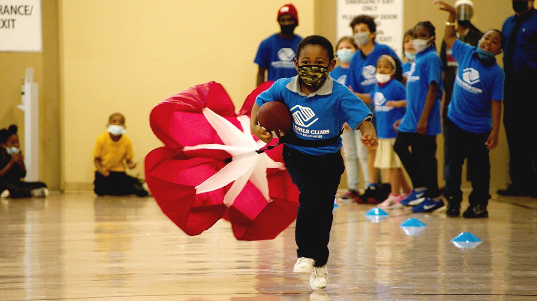 A child with the John H. Dickerson Boys andÂ Girls Club tests out a resistance parachute. Courtesy photo