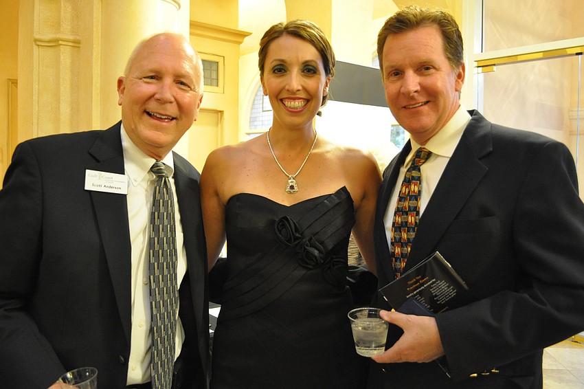 Auctioneer Scott Anderson, model Jennifer Tarasi and Tony Strong