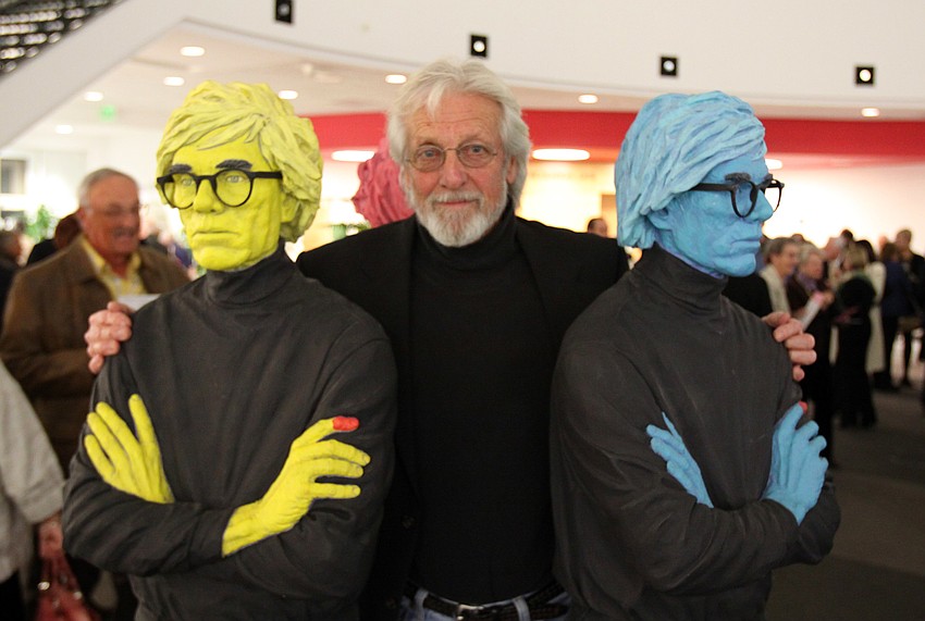Jack Dowd stands between two of his sculptures that he made of Andy Warhol in 2007.
