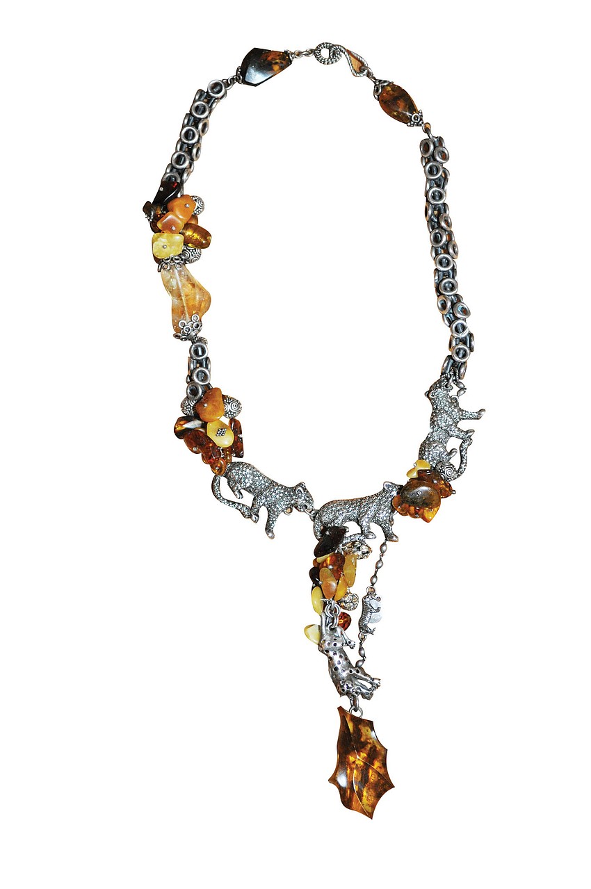 VINTAGE NECKLACE 
'I saw this in a store in San Miguel, Mexico, and my husband went back and got it for my birthday. It has lions, tigers and elephants and the African feel I'm drawn to.'