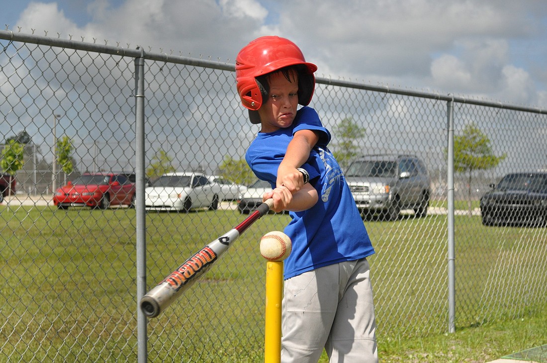 Logan Britton takes a cut off a tee at Wednesday's baseball clinic, which was organized by FPC coach Jordan Butler. PHOTOS BY ANDREW O'BRIEN