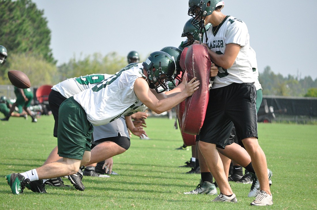 Flagler Palm Coast players run through drills Monday during the first official day of fall football practice. PHOTOS BY ANDREW O'BRIEN