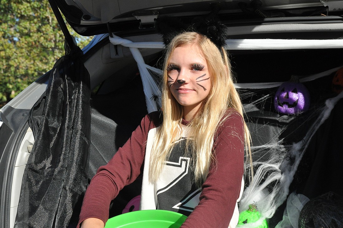 Izabela Lagocki hands out candy at the trunk or treat. PHOTOS BY SHANNA FORTIER