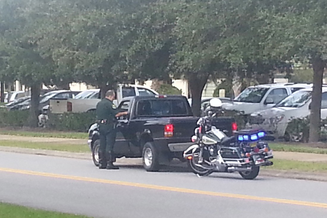 Deputy Kenny Goncalves checks for seatbelts on Cypress Branch Way. (Courtesy photo by Michael Van Buren)