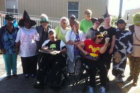 Students and staff at the Adult Activities Center dressed up for Halloween. Sally Smith, on the far-right side, is dressed as Shrek. (Courtesy photos)