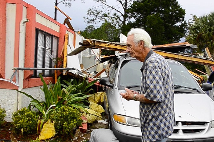 Palm Coast resident John Coberly looks at damage to his B section house the morning after a tornado struck the night of Dec. 14. (Photo by Steven Sobel)