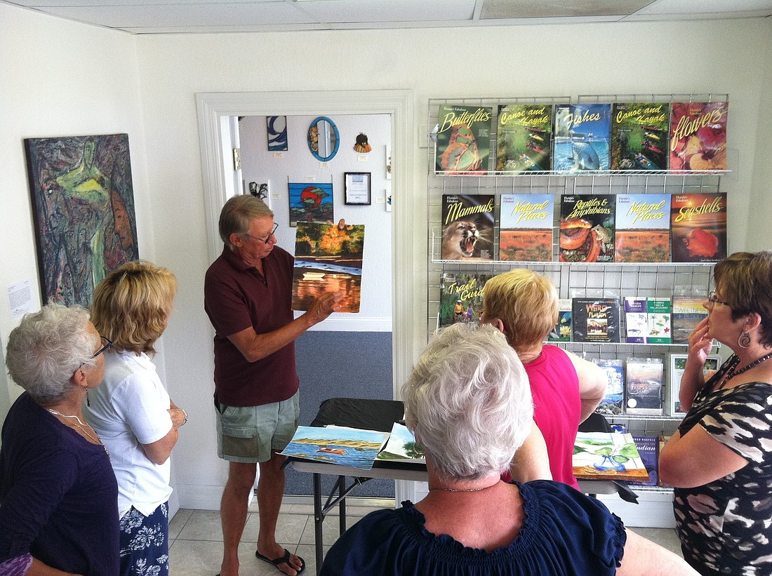 Watercolor artist Harry Thompson critiques a student's painting at Ocean Books & Art. (Courtesy photo)