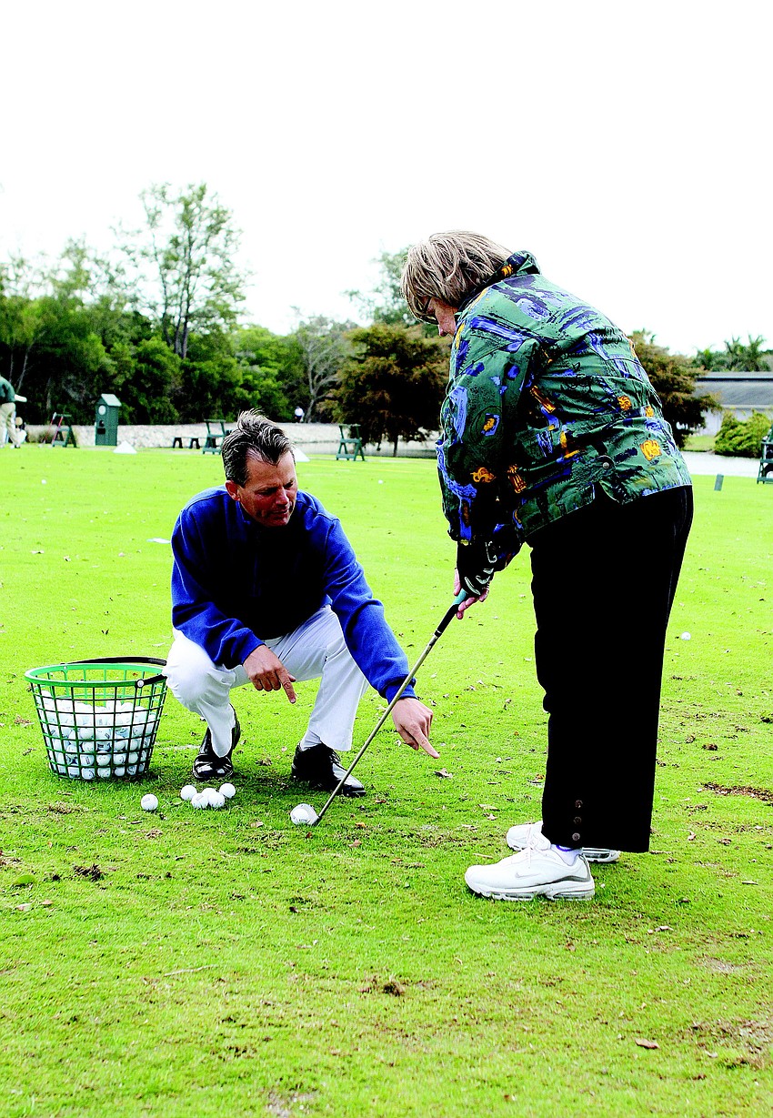 Longboat Key Club and Resort Director of Golf Terry O'Hara gives some pointers to Linda Abrahamson during a private lesson Jan. 24, at the club.