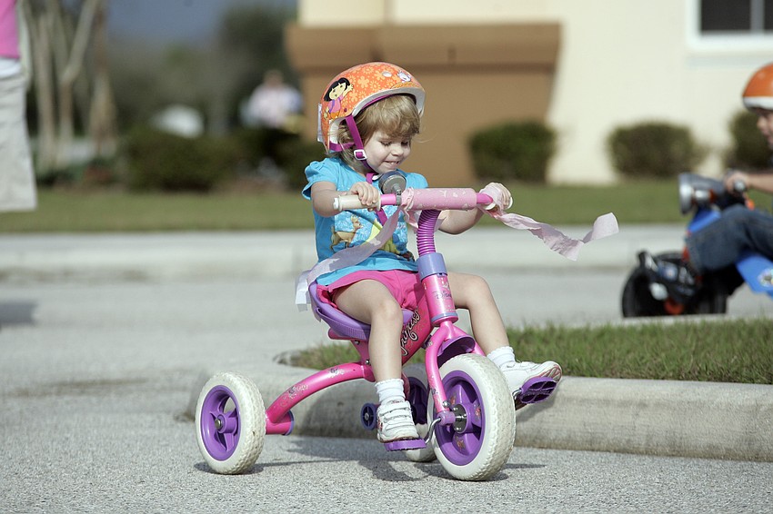 Three-year-old Jill Scheiderman was all smiles as she rode around the parking lot.