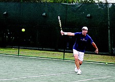 Mark Kapusta runs to hit a backhand during a doubles match Saturday, Feb. 5 at the tennis courts at Payne Park.