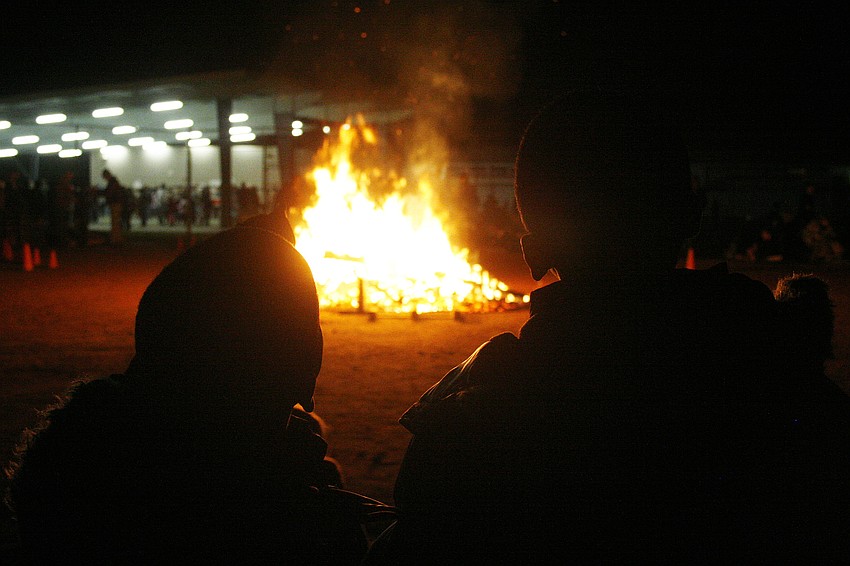 Brothers Jordan and Jaquavius Bing loved the warmth the fire gave during the cold evening.
