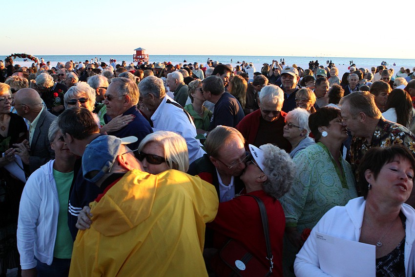 300 couples kiss after renewing their vows to one another at the Say I Do, Again ceremony, Monday, Feb. 14 on Siesta Key Beach.