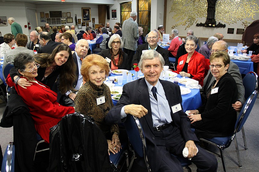 One of the many tables at Shabbat Alive! dinner pose for a picture on Friday, Feb. 11 at Temple Emanu-El.
