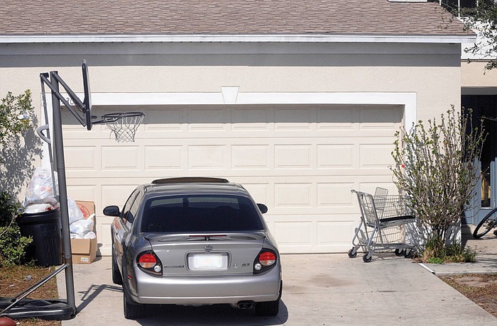 A shopping cart and trash sit in front of a home in Greenbrook Dale.