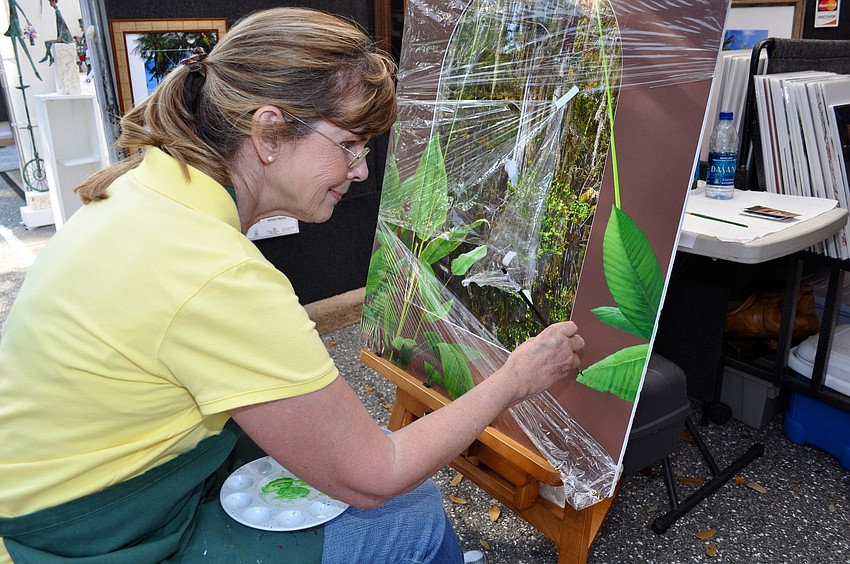 Susan Kelleghan paints beyond the border of a photograph taken by her husband, Bill Miller.