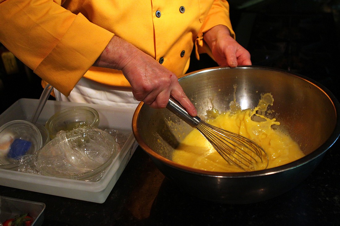 Chef Raymond wisks up some eggs to make the final course during the second class for this season's Chef Raymond's Famous Lesson Luncheons on Wednesday, Feb. 9 at Euphemia Haye.
