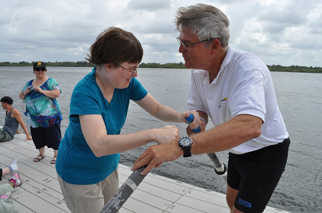 Amy Cross of Community Haven gets a quick on-dock lesson in rowing from Joe Dobson of the Sarasota County Rowing Club.