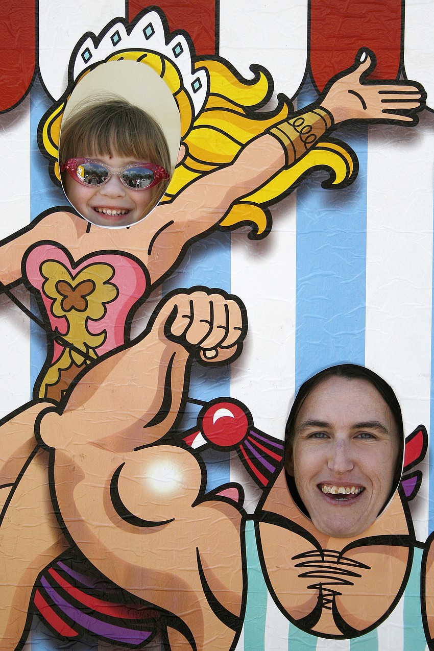 Kaylee Burns, 4, and her mom, Christine, giggled as they posed for this carnival caricature photo.