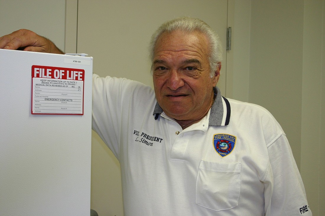 Longboat Key Fire Rescue volunteer president Lew Simon displays a File of Life magnet.