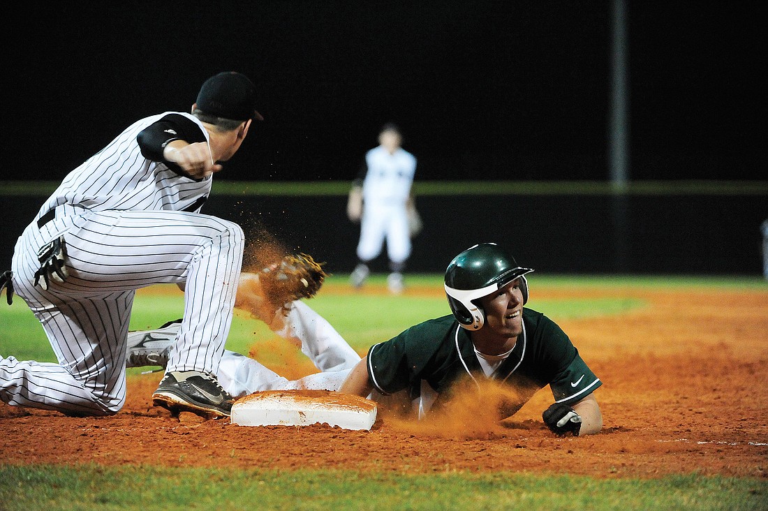 Shane Davidson slides safely back into first base during Lakewood Ranch's 9-1 victory over Braden River Feb. 22.