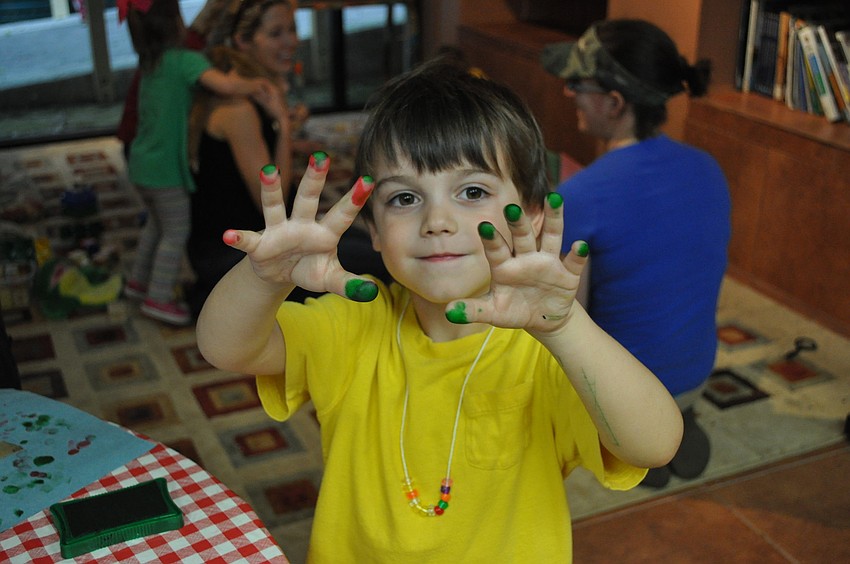 Ronan Zeitler proudly shows off his paint-covered fingers.