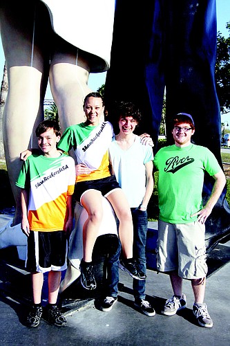 Cal Davidson-Turner, Kim Hyslop, Morgyn Stauffer and Garrett Lyons meet every Saturday morning at the Unconditional Surrender statue for their long run.