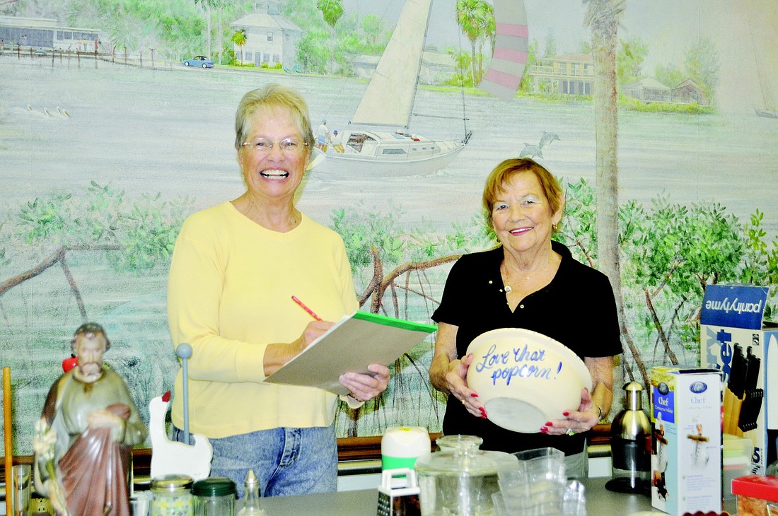 Dionne Reinert and Dee Tornillo set prices for household items for the Royal Rummage Sale.