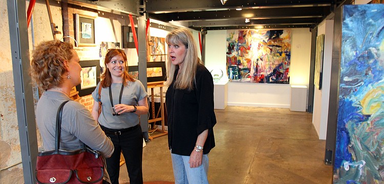 Krystyna Sznurkowski and Sarah Kunkel talk with Lori Frary, owner of Frary Gallery in the Rosemary District during Rosemary Rising.