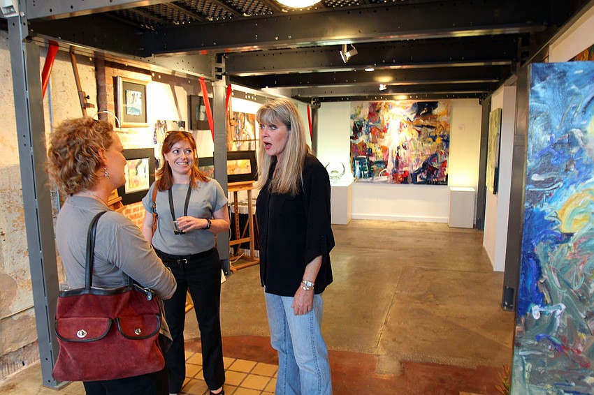 Krystyna Sznurkowski and Sarah Kunkel talk with Lori Frary, owner of Frary Gallery in the Rosemary District during Rosemary Rising.
