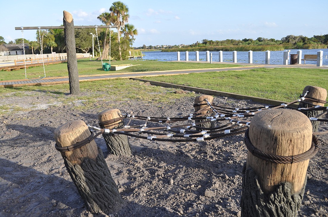 The new feature at the East County park includes swings, a spider web and a series of logs on which children can climb.