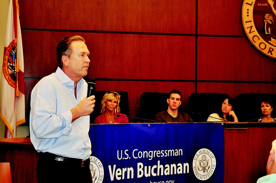 U.S. Rep. Vern Buchanan discusses the need for reducing spending and increasing savings at a town hall meeting Saturday.