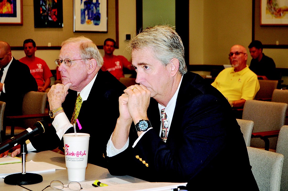Town Manager Bruce St. Denis, right, and town labor attorney Reynolds Allen discuss why the town is not able to give the firefighters a contract that involves spending more money.