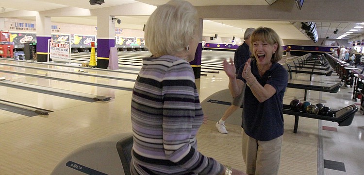 Lola Keeler gets congratulated by Jane Johnson from SYC on Keeler's strike during the BKYC v. SYC bowling tournament on Monday, Feb. 28 at Sarasota Lanes.