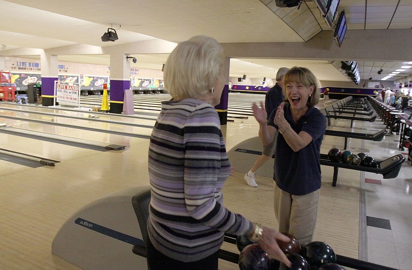 Lola Keeler gets congratulated by Jane Johnson from SYC on Keeler's strike during the BKYC v. SYC bowling tournament on Monday, Feb. 28 at Sarasota Lanes.