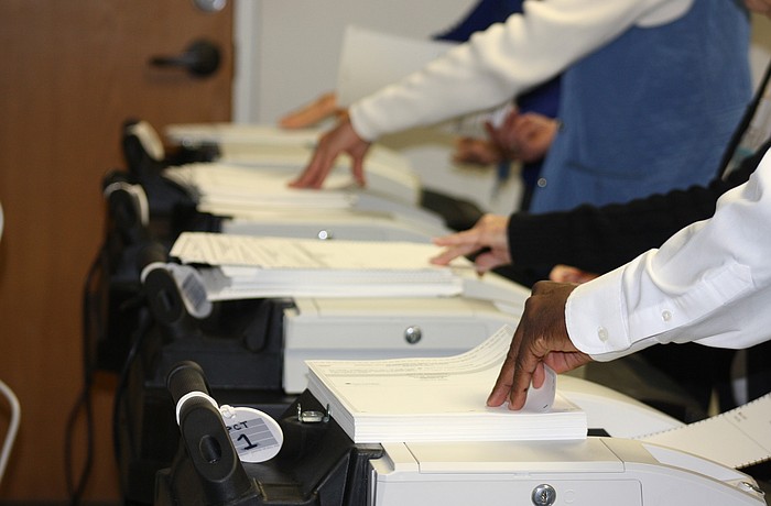 Supervisor of Elections Office employees fed more than 3,400 ballots through scanning machines during the recount.