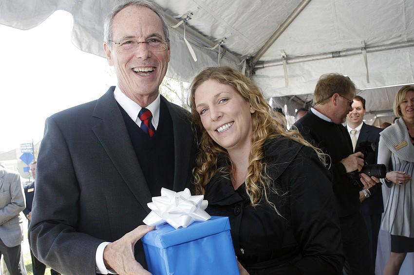 LECOM student Lauren Acton, right, was the guest of honor at Pat Neal's 8,000th home sale celebration March 11.