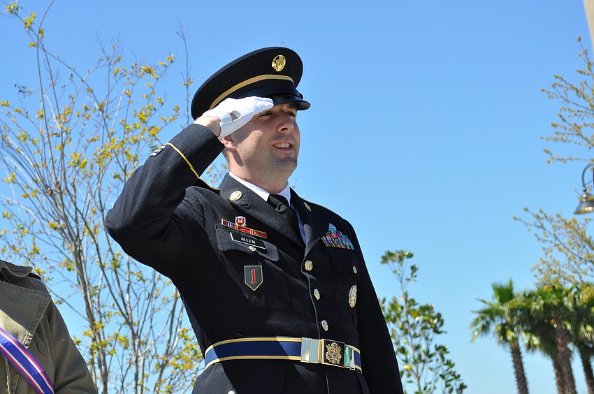 Sgt. Lyle Allen salutes during 