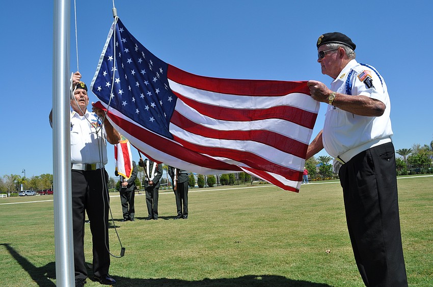 Members of American Legion Post 24 raised the flag during the ceremony.