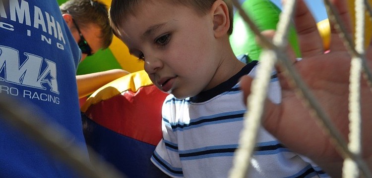 Mill Creek resident Dylan Giunta, 3, had fun on the bounce house with his cousin.