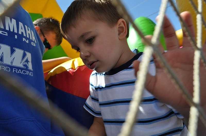 Mill Creek resident Dylan Giunta, 3, had fun on the bounce house with his cousin.