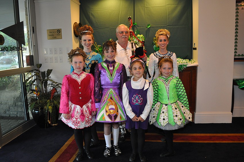 A group of adorable Irish dancers surrounds bagpiper Bill Buckley before he pipes them into the dining room for their St. Patrick's Day performance.