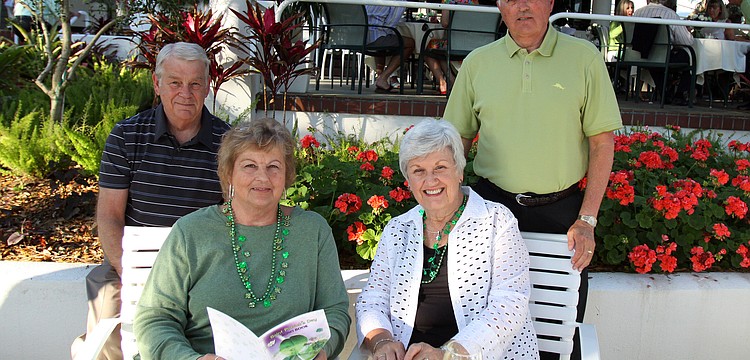 Terry and Barb Sullivan with Bev and Tom Buckman enjoy themselves and their Irish song books on Thursday, March 17 at Longboat Key Club's outdoor Harbourside dining patio.