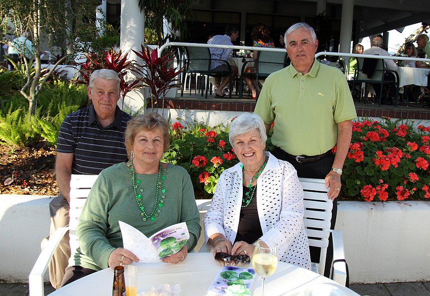 Terry and Barb Sullivan with Bev and Tom Buckman enjoy themselves and their Irish song books on Thursday, March 17 at Longboat Key Club's outdoor Harbourside dining patio.
